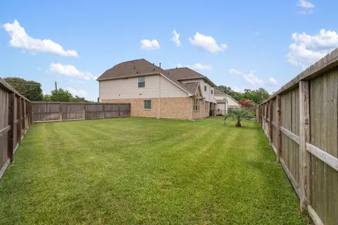 a view of a house with a yard and sitting area