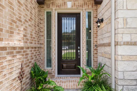 a view of a door and chair in the balcony