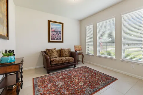 a living room with furniture and a rug