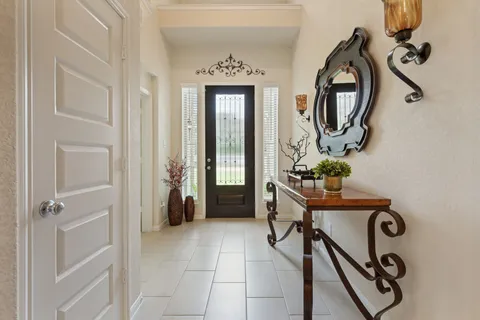 a view of hall way with furniture and mirror