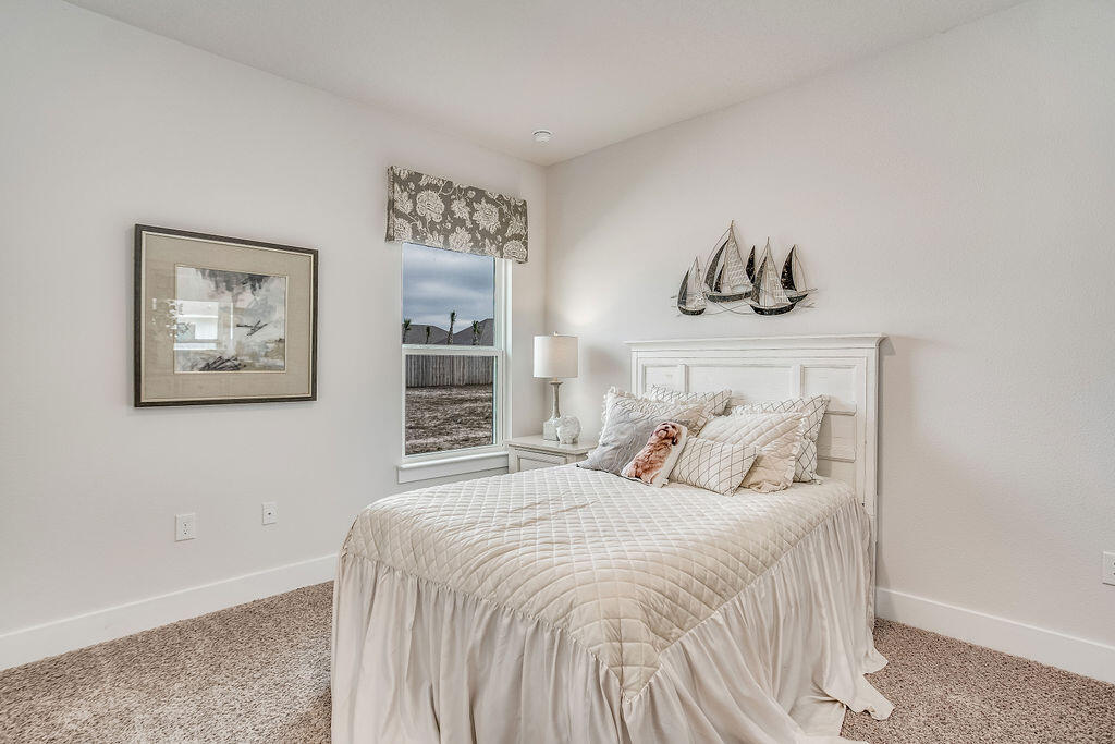 8587 Bluebell Street Milton, FL 32583 - Photo 20 of 30 a bedroom with a bed and painting on the wall