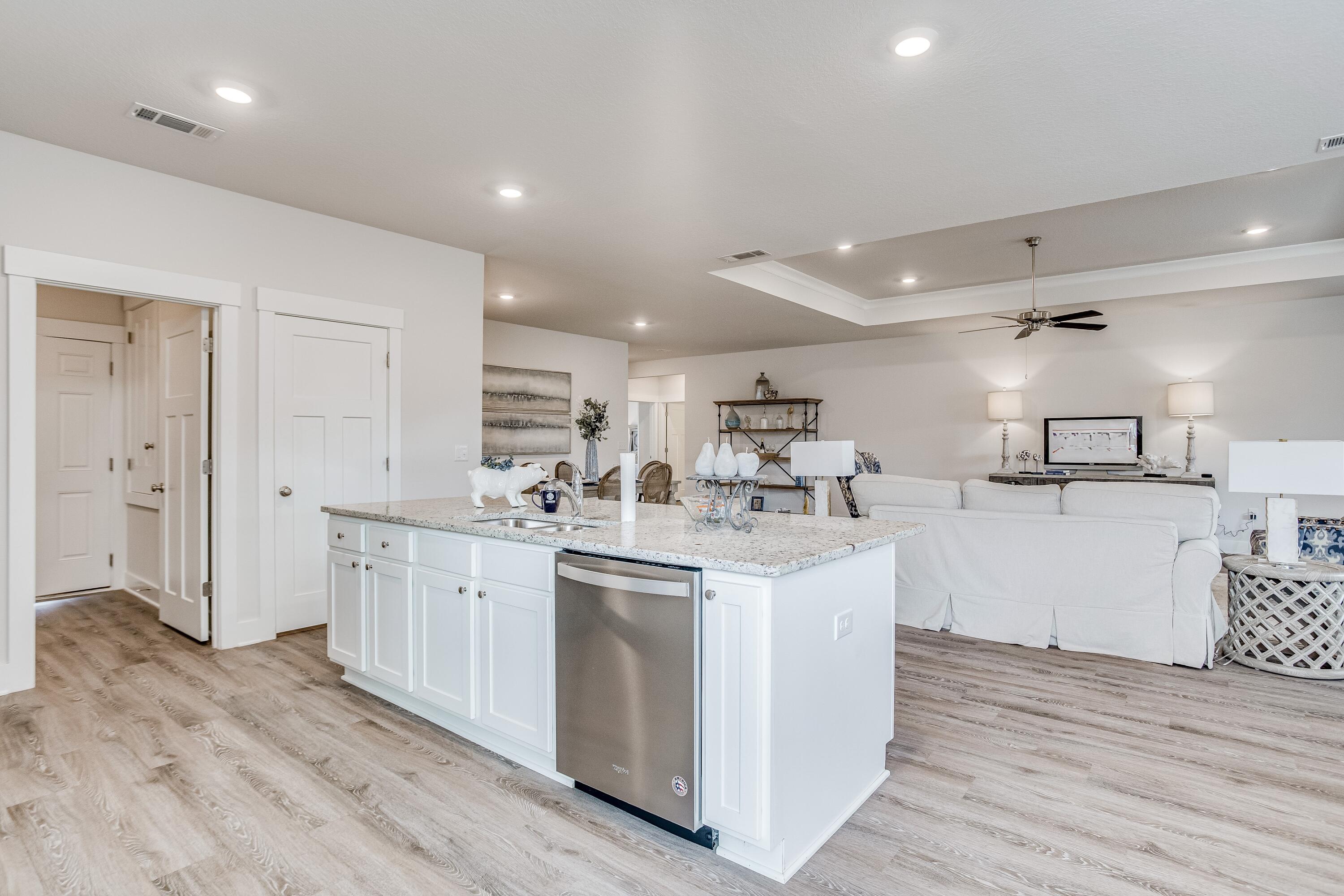 8587 Bluebell Street Milton, FL 32583 - Photo 6 of 30 a kitchen with white cabinets appliances and sink