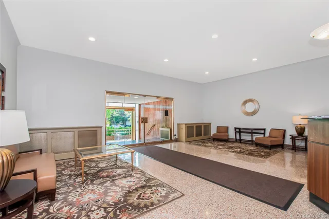 a living room with furniture rug and window