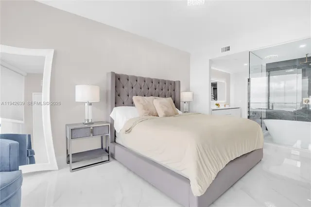 a bedroom with a bed and a night stand