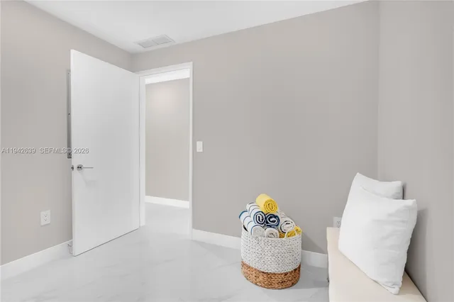 a balcony with furniture and a potted plant