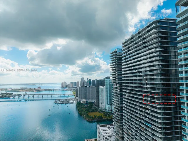 a living room with furniture and large windows