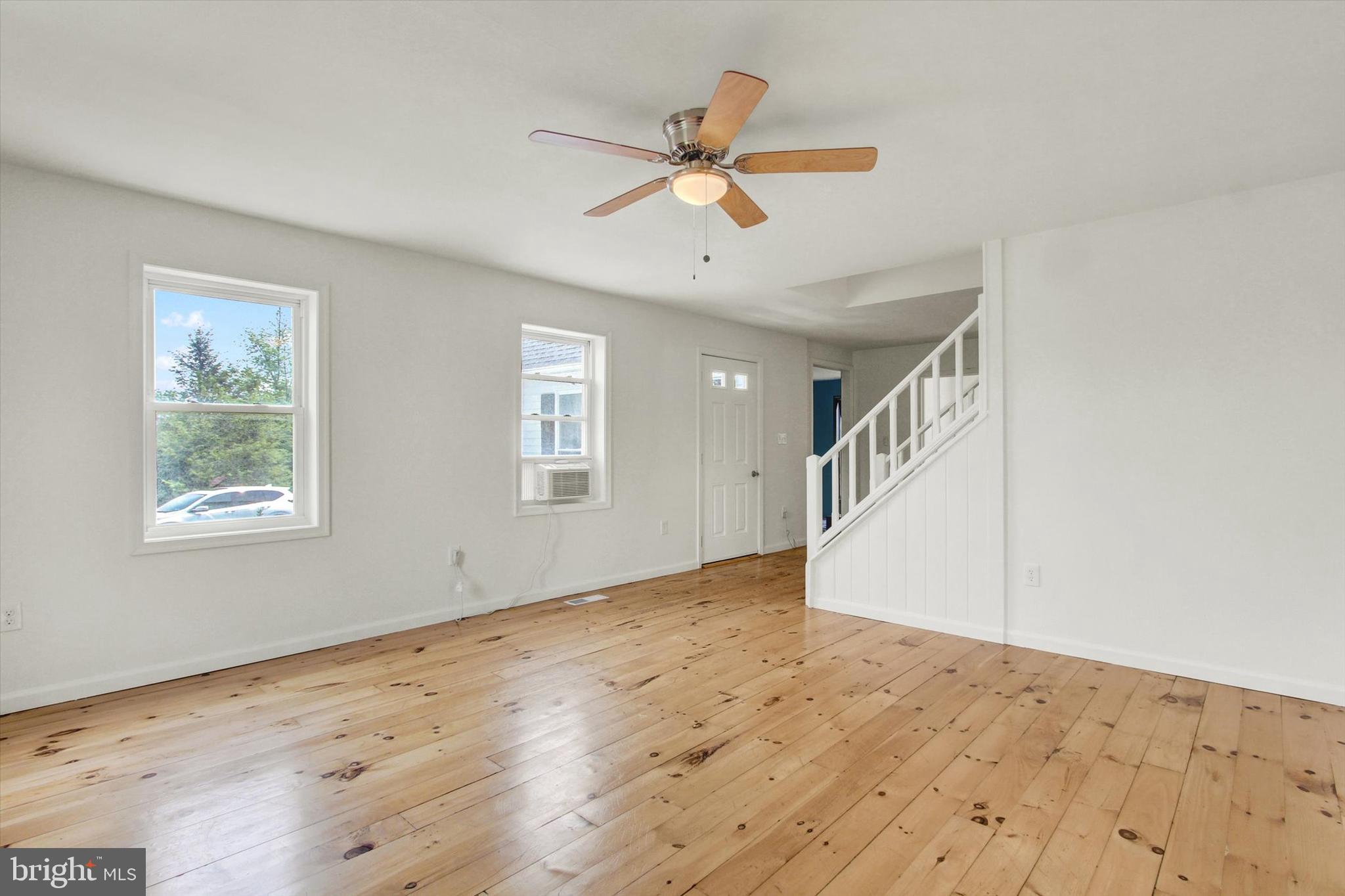 651 Alexander Spring Road Carlisle, PA 17015 - Photo 13 of 28 a view of an empty room with wooden floor and a ceiling fan