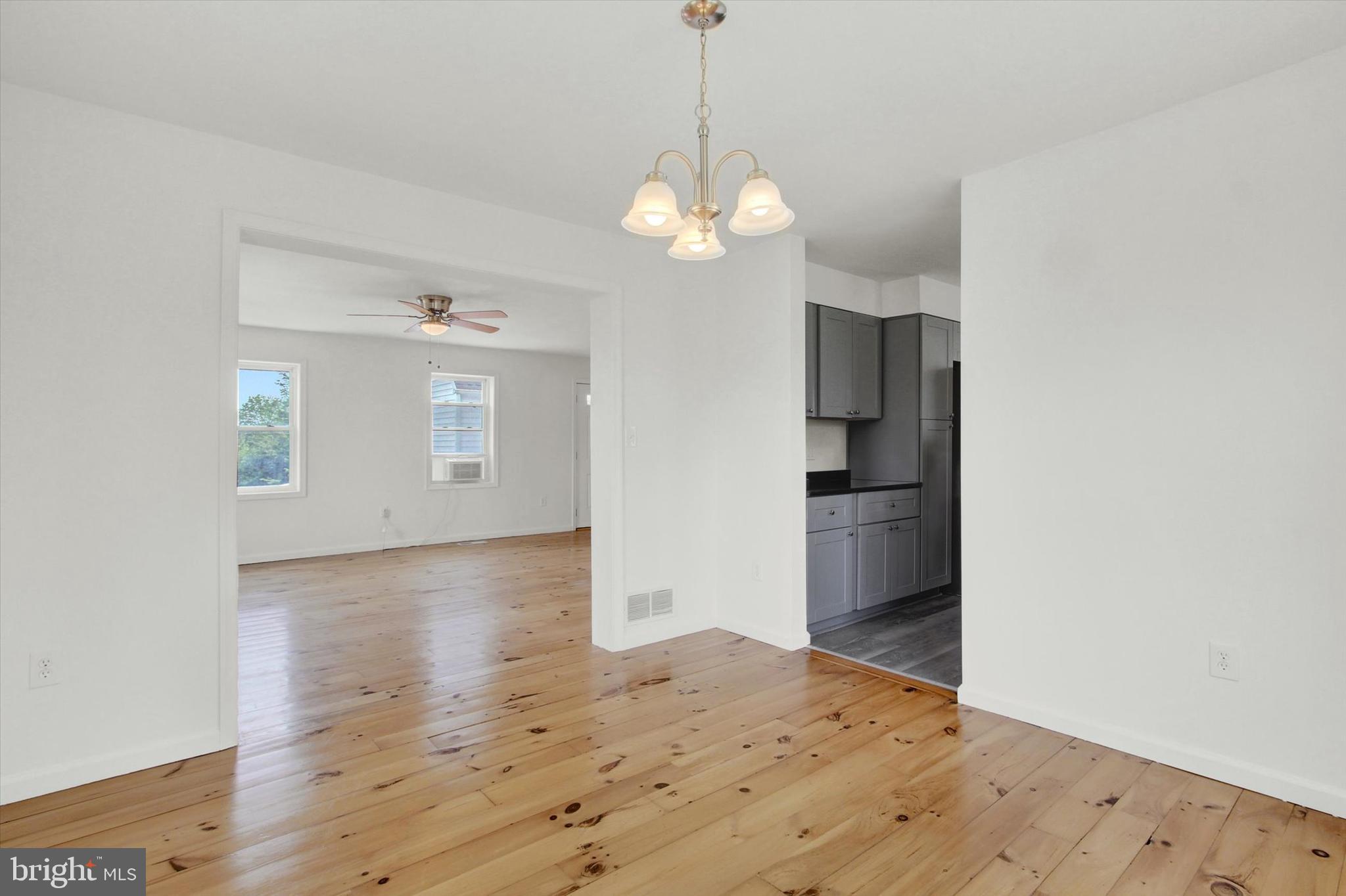 651 Alexander Spring Road Carlisle, PA 17015 - Photo 15 of 28 a view of a kitchen with wooden floor and a chandelier