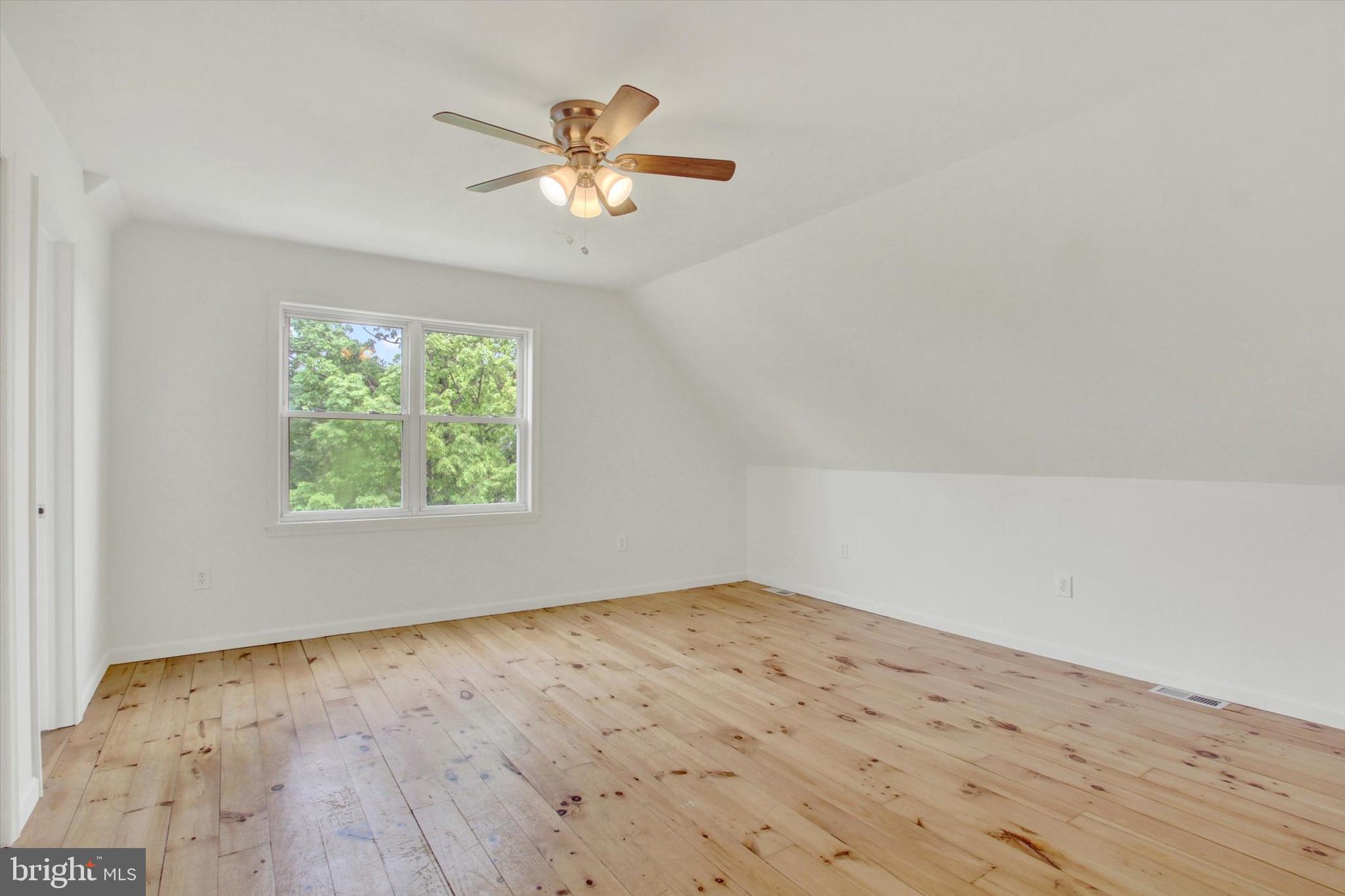651 Alexander Spring Road Carlisle, PA 17015 - Photo 17 of 28 an empty room with wooden floor and chandelier fan