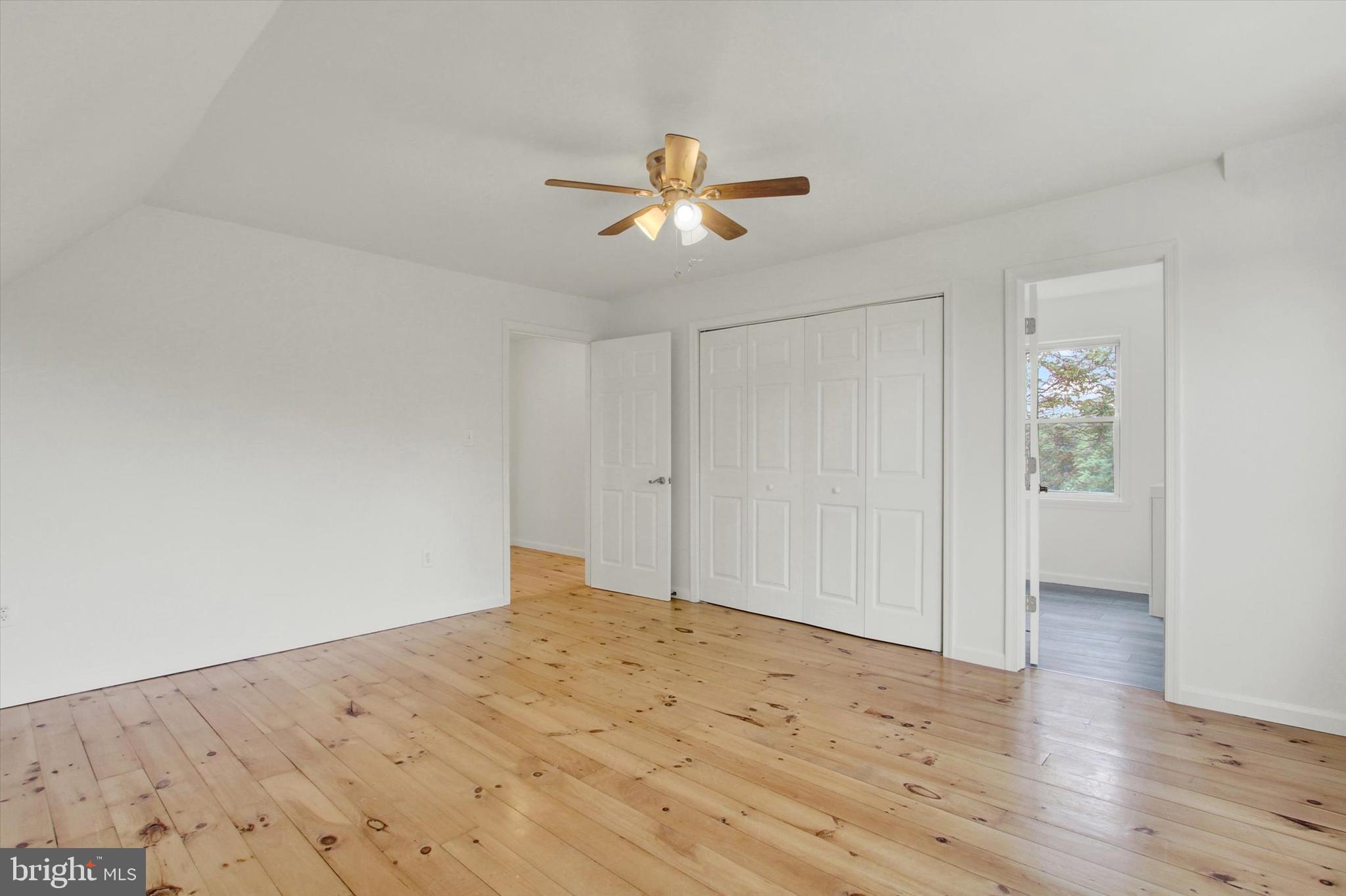 651 Alexander Spring Road Carlisle, PA 17015 - Photo 18 of 28 a view of empty room with wooden floor and ceiling fan