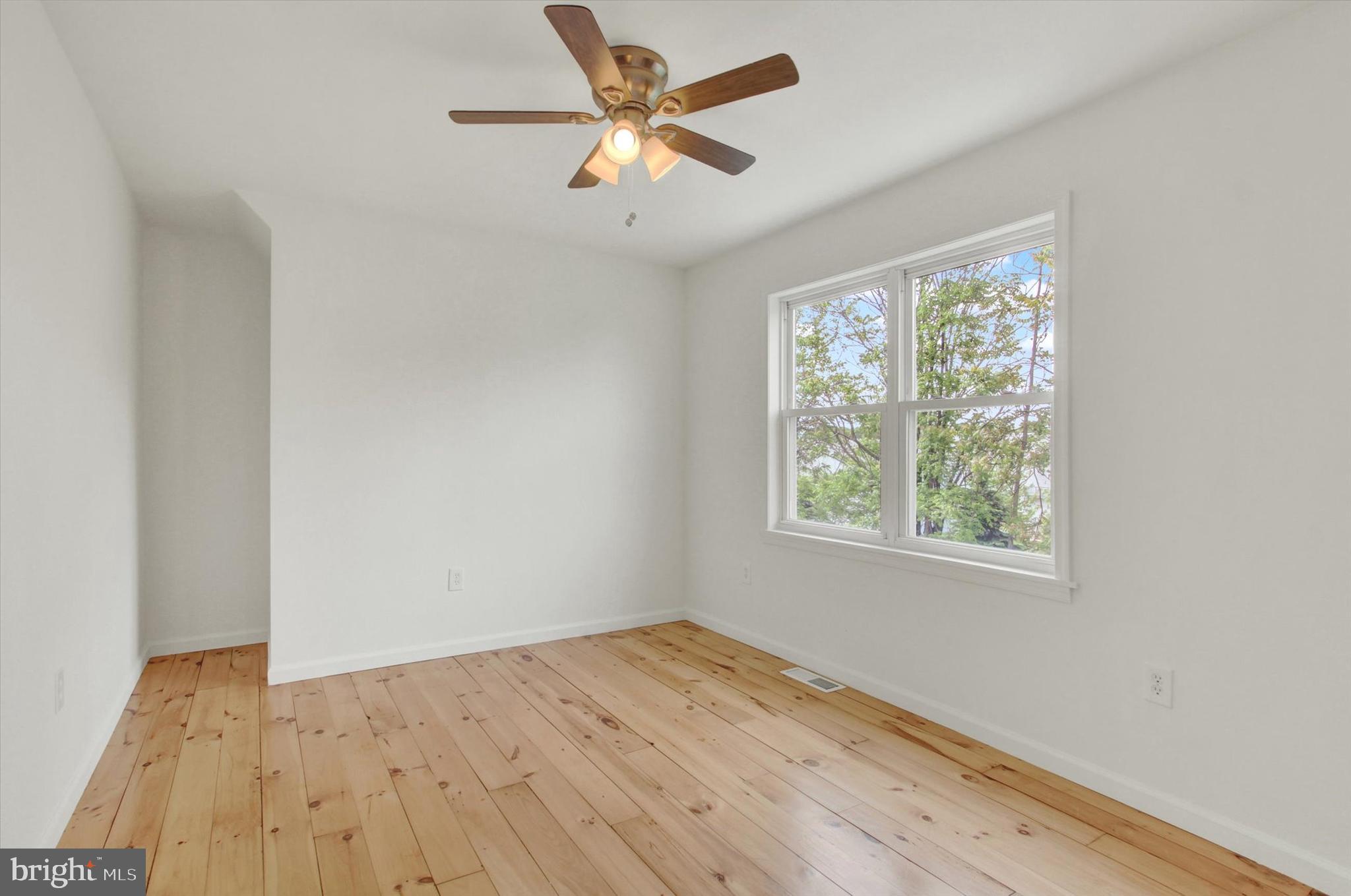 651 Alexander Spring Road Carlisle, PA 17015 - Photo 21 of 28 a view of empty room with wooden floor and fan