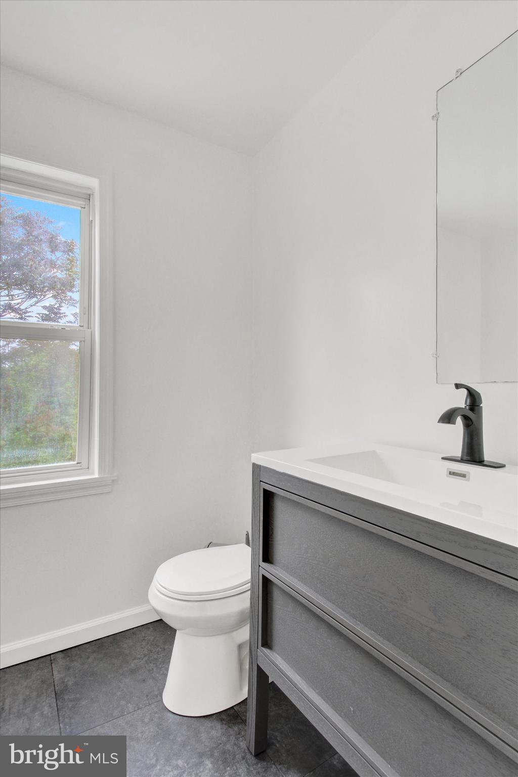 651 Alexander Spring Road Carlisle, PA 17015 - Photo 22 of 28 a bathroom with a toilet a sink and a window