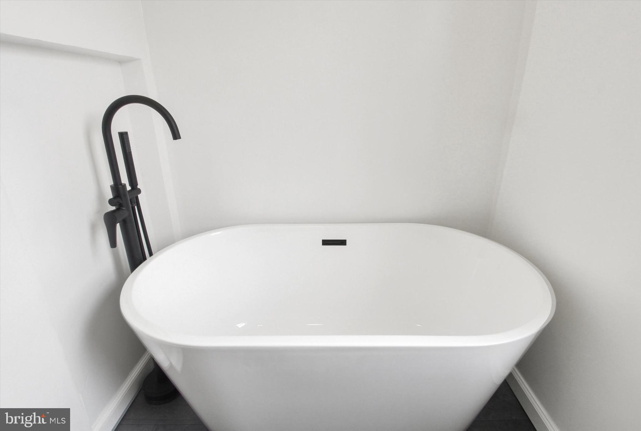 651 Alexander Spring Road Carlisle, PA 17015 - Photo 23 of 28 a white bath tub sitting in a bathroom