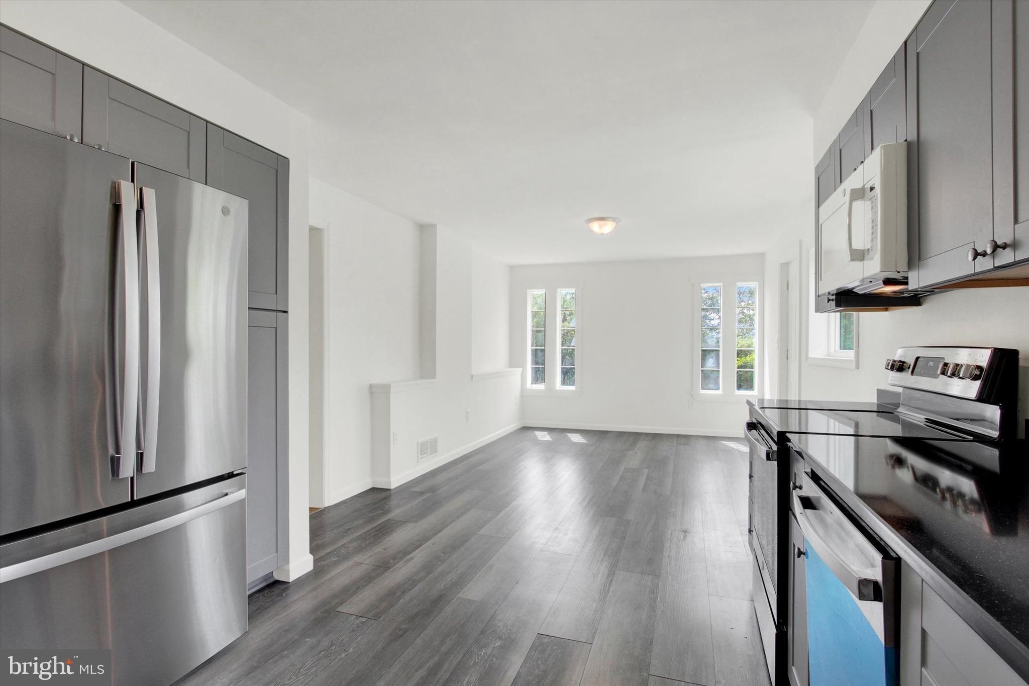 651 Alexander Spring Road Carlisle, PA 17015 - Photo 7 of 28 a view of a kitchen with wooden floor electronic appliances and windows