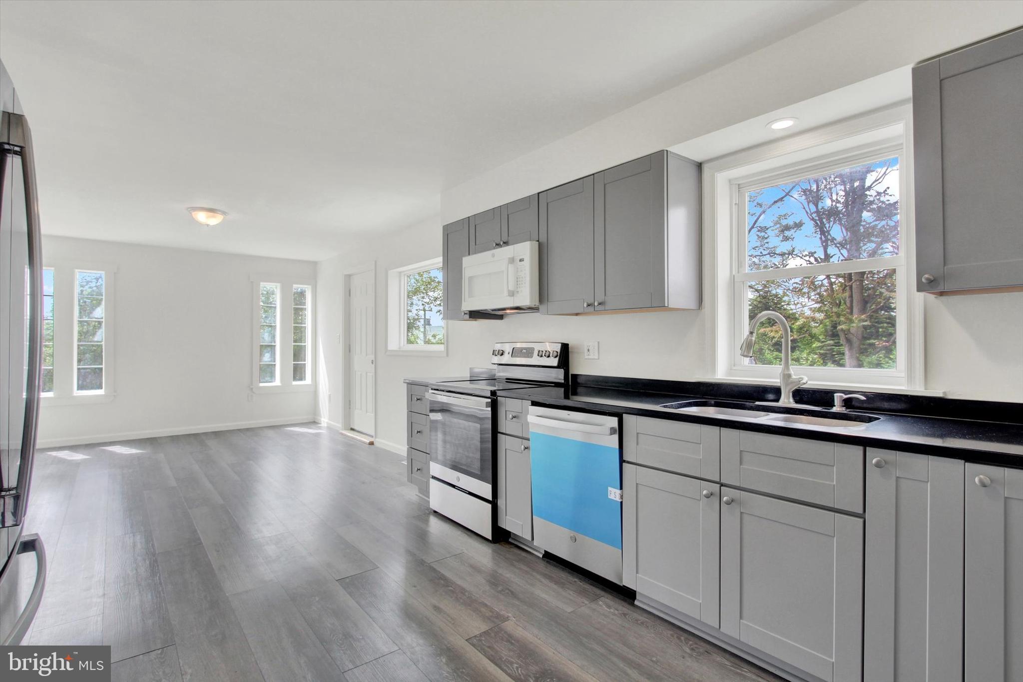 651 Alexander Spring Road Carlisle, PA 17015 - Photo 8 of 28 a kitchen with stainless steel appliances granite countertop a sink a stove cabinets and wooden floor