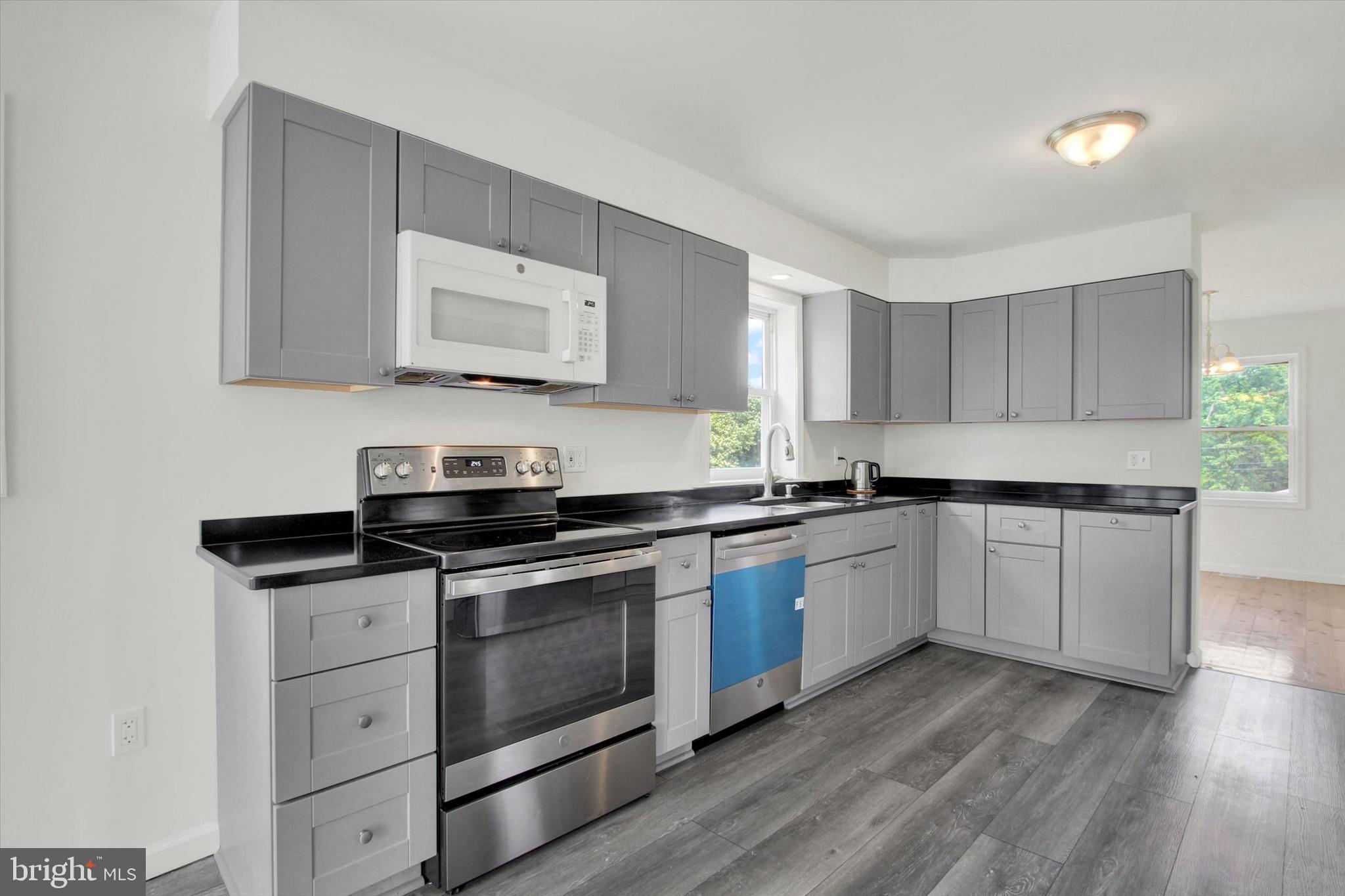 651 Alexander Spring Road Carlisle, PA 17015 - Photo 10 of 28 a kitchen with stainless steel appliances granite countertop a stove a sink and a microwave