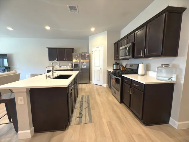 a living room with a couch and chandelier
