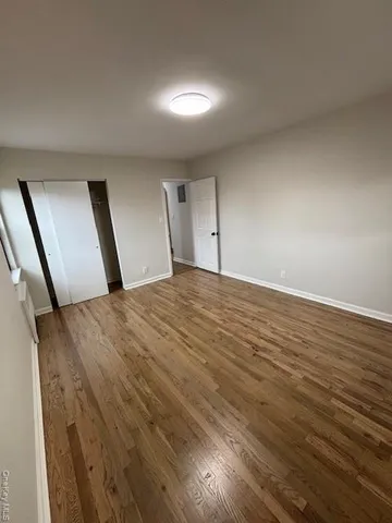 a view of an empty room and wooden floor