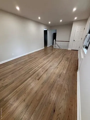 an empty room with wooden floor