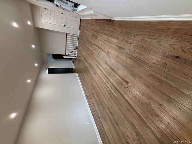 219-07 74th Avenue, Unit 447B2 Queens, NY 11364 - Photo 4 of 15 an empty room with wooden floor