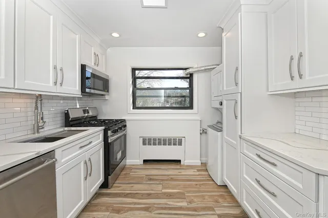 a kitchen with granite countertop a stove and a sink
