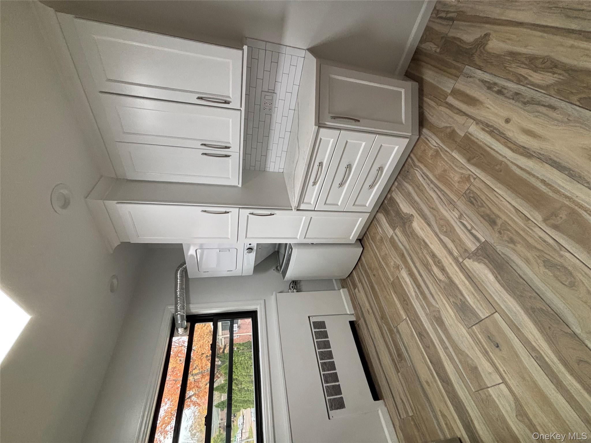 219-07 74th Avenue, Unit 447B2 Queens, NY 11364 - Photo 8 of 15 a view of a kitchen with wooden floor