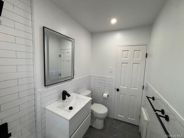 219-07 74th Avenue, Unit 447B2 Queens, NY 11364 - Photo 9 of 15 a bathroom with a toilet sink and mirror