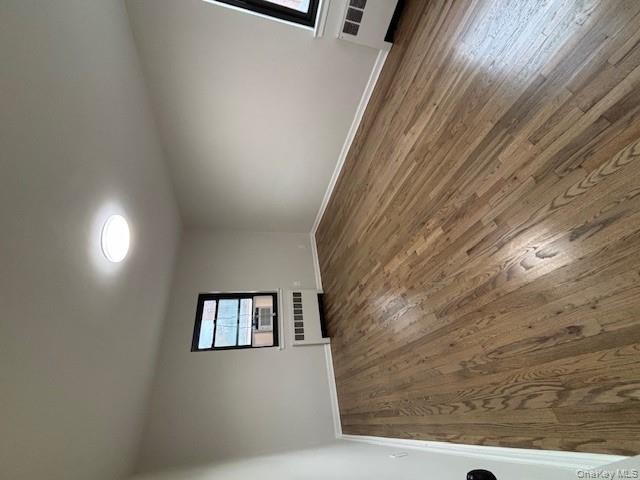 219-07 74th Avenue, Unit 447B2 Queens, NY 11364 - Photo 10 of 15 an empty room with wooden floor closet and windows