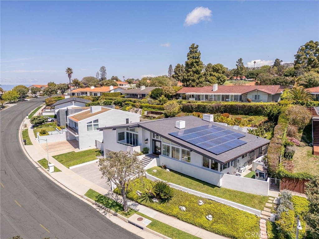 an aerial view of residential houses with outdoor space and swimming pool