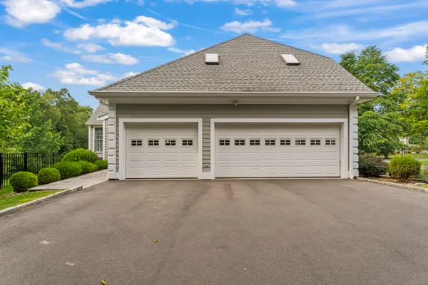 a view of a house with a garage and outdoor kitchen