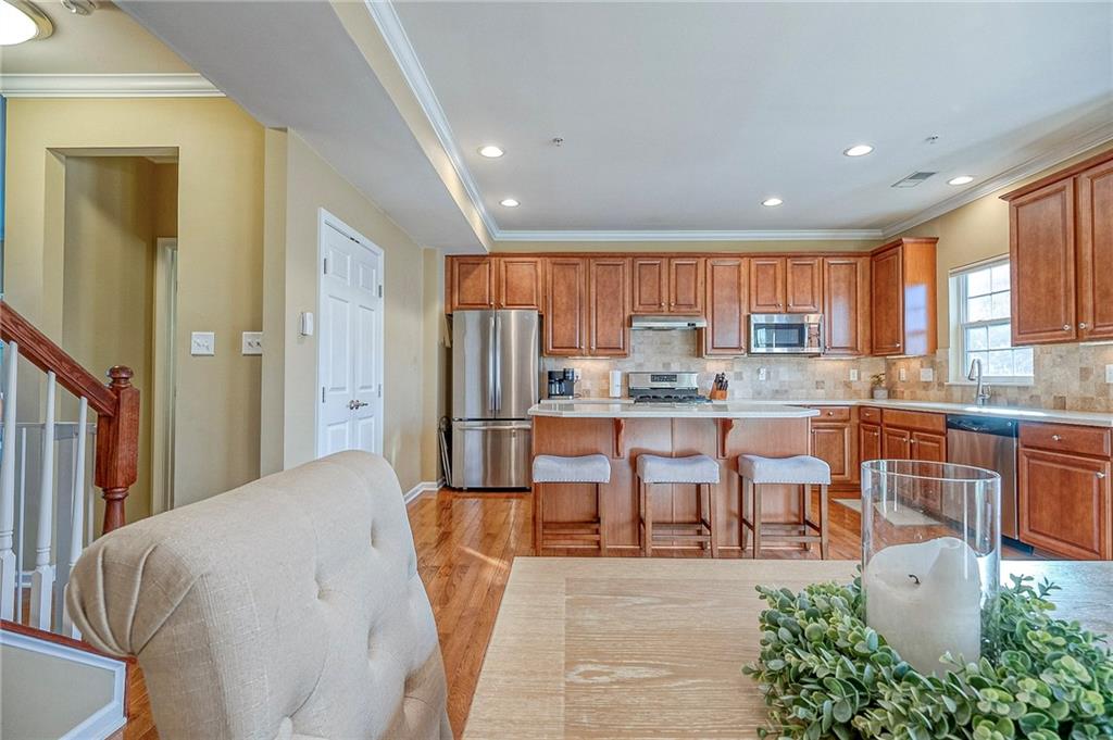 204 Broadstone Drive Mars, PA 16046 - Photo 11 of 32 a kitchen with stainless steel appliances kitchen island granite countertop a refrigerator a stove top oven and a sink with island