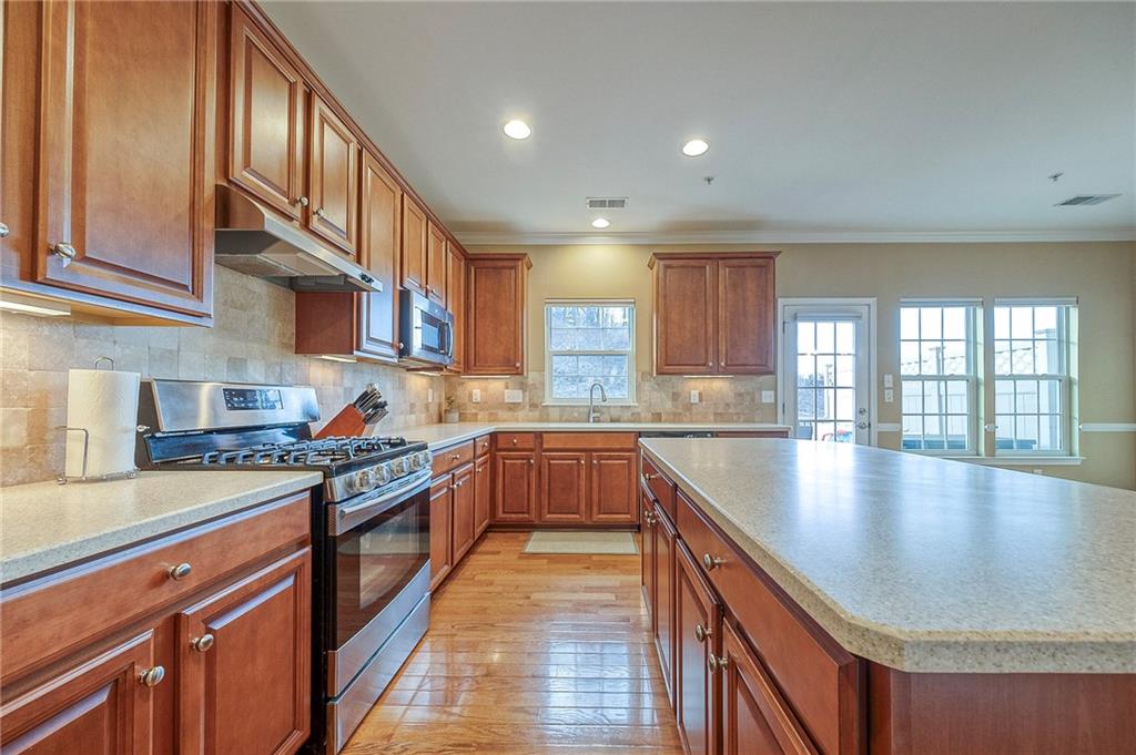 204 Broadstone Drive Mars, PA 16046 - Photo 8 of 32 a kitchen with stainless steel appliances granite countertop a sink stove and cabinets