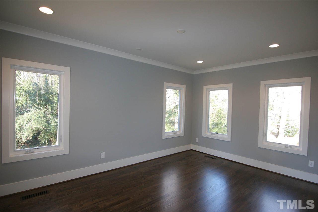 915 Marilyn Drive Raleigh, NC 27607 - Photo 14 of 25 a view of an empty room with wooden floor and a window