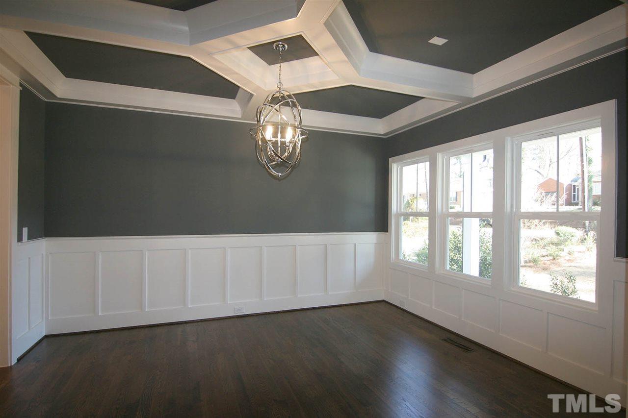 915 Marilyn Drive Raleigh, NC 27607 - Photo 7 of 25 a view of an empty room with wooden floor and a window