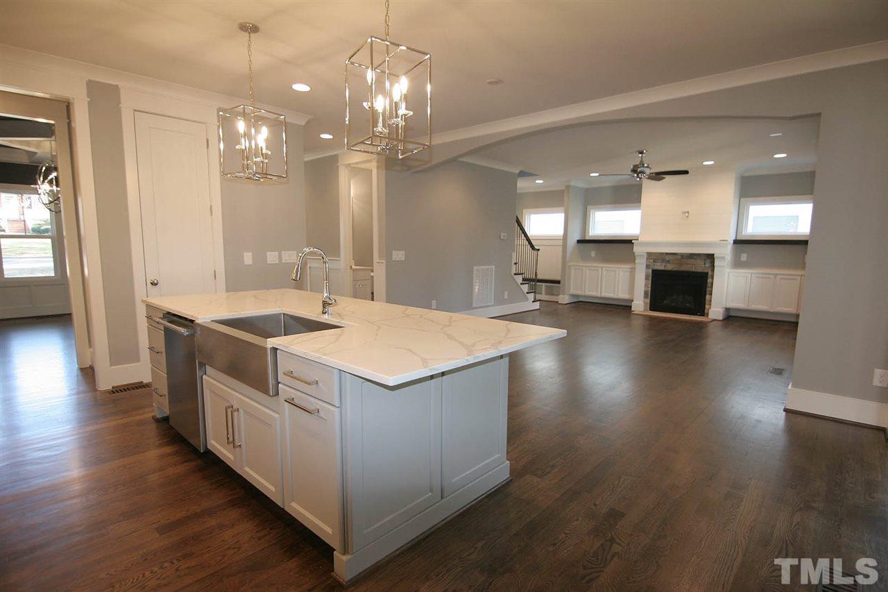 915 Marilyn Drive Raleigh, NC 27607 - Photo 10 of 25 a kitchen with stainless steel appliances granite countertop a sink a stove and a wooden floor