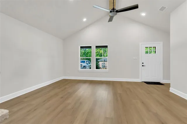 wooden floor in an empty room with a window