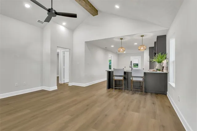 a view of a room with wooden floor and furniture