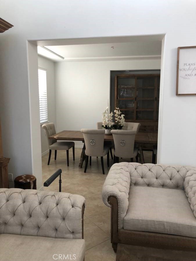 14653 Meadowsweet Drive Eastvale, CA 92880 - Photo 11 of 15 a living room with furniture and a fireplace