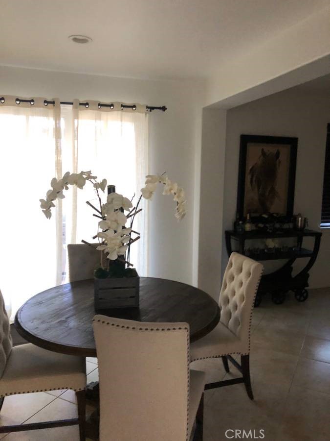 14653 Meadowsweet Drive Eastvale, CA 92880 - Photo 3 of 15 a living room with furniture and a potted plant
