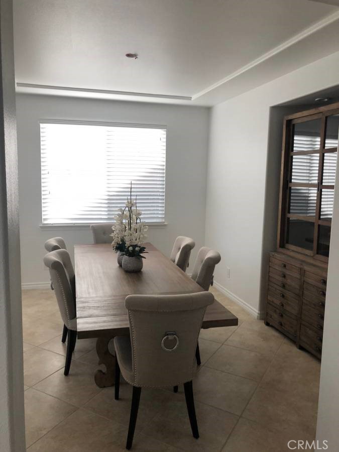 14653 Meadowsweet Drive Eastvale, CA 92880 - Photo 7 of 15 a dining room with furniture and window