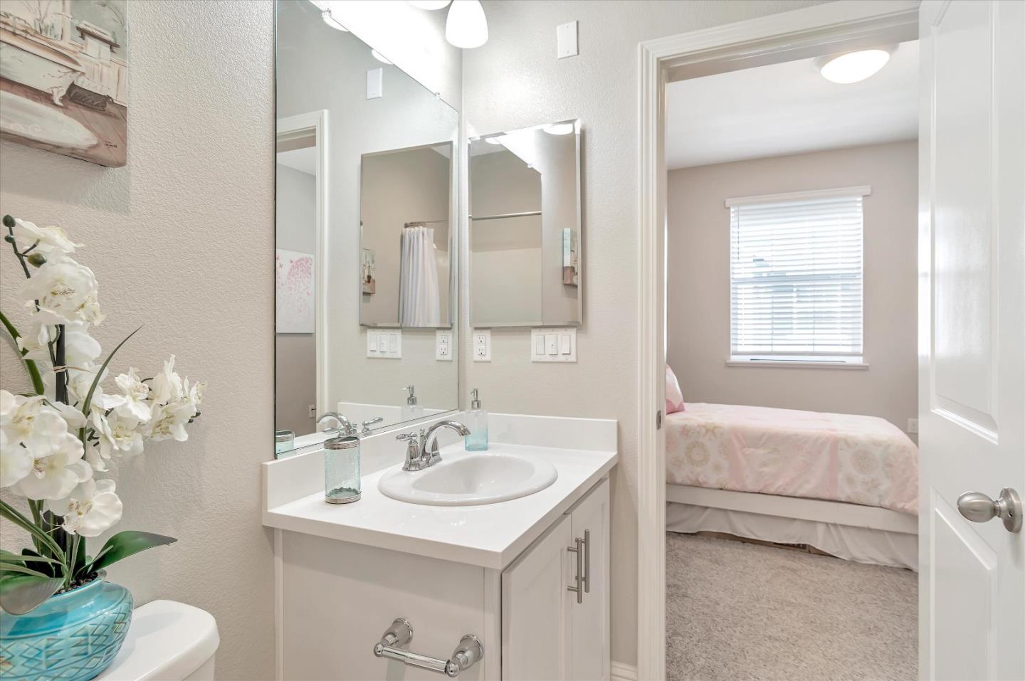 305 Wild Rose Way Milpitas, CA 95035 - Photo 19 of 41 a en suite bathroom with a sink and mirror with toilet