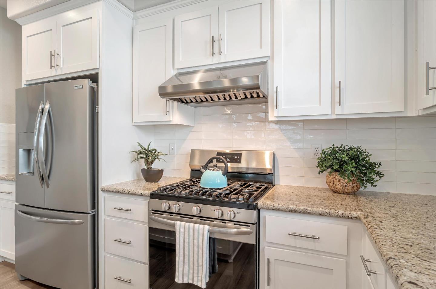 305 Wild Rose Way Milpitas, CA 95035 - Photo 4 of 41 a kitchen with stainless steel appliances granite countertop a refrigerator sink stove and white cabinets