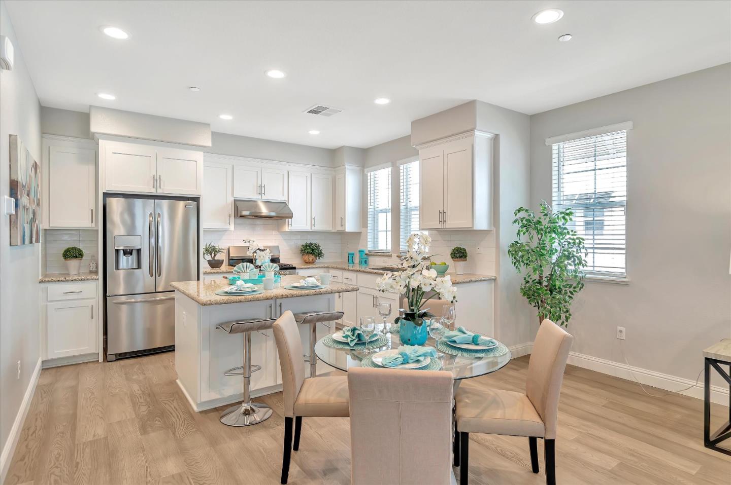 305 Wild Rose Way Milpitas, CA 95035 - Photo 5 of 41 a kitchen with a refrigerator and white table chairs