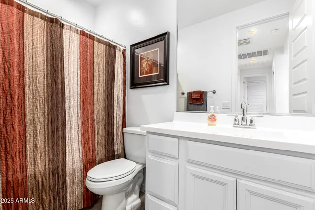 a bathroom with a sink a toilet and mirror