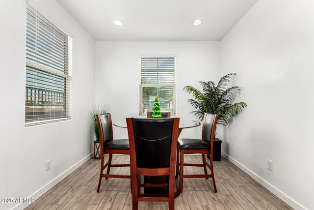 a dining room with furniture and wooden floor