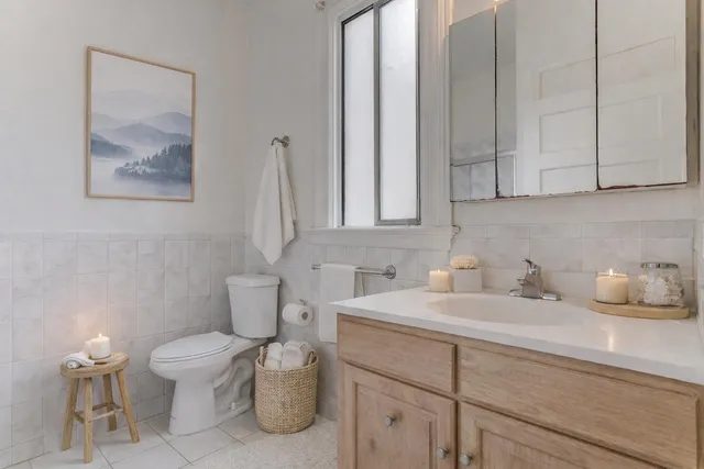 a bathroom with a toilet sink and mirror