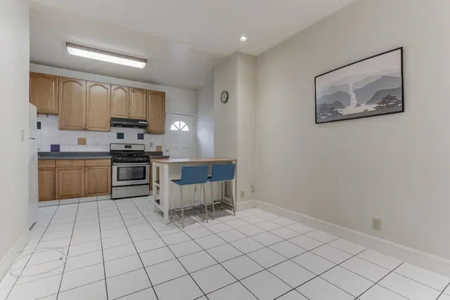 a kitchen with stainless steel appliances a stove a sink a microwave and a refrigerator