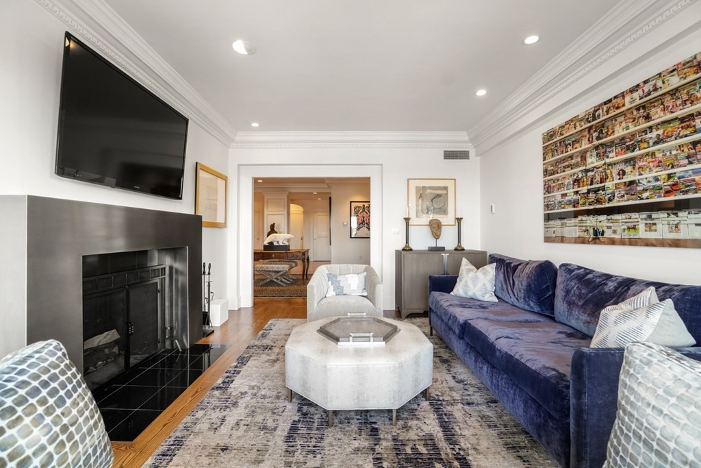 333 Commonwealth Avenue, Unit PH22 Boston, MA 02115 - Photo 15 of 42 a living room with furniture and a fireplace