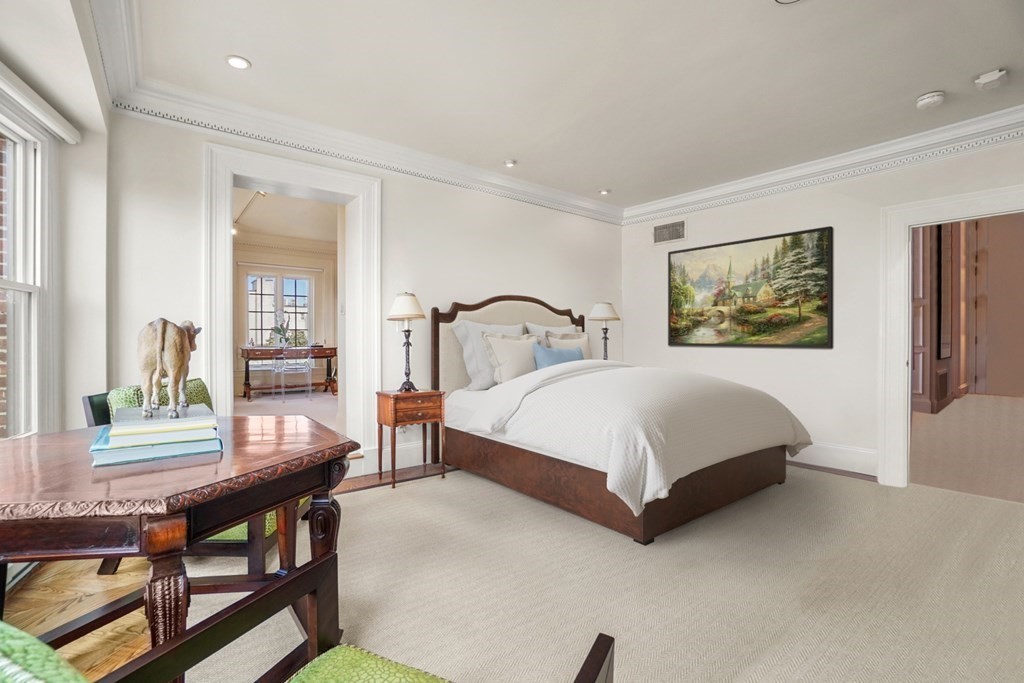 333 Commonwealth Avenue, Unit PH22 Boston, MA 02115 - Photo 17 of 42 a bedroom with a bed table and a window