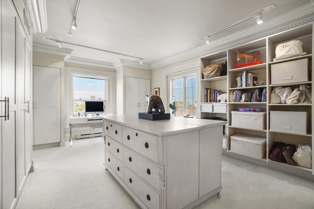 333 Commonwealth Avenue, Unit PH22 Boston, MA 02115 - Photo 19 of 42 a living room with furniture and a book shelf